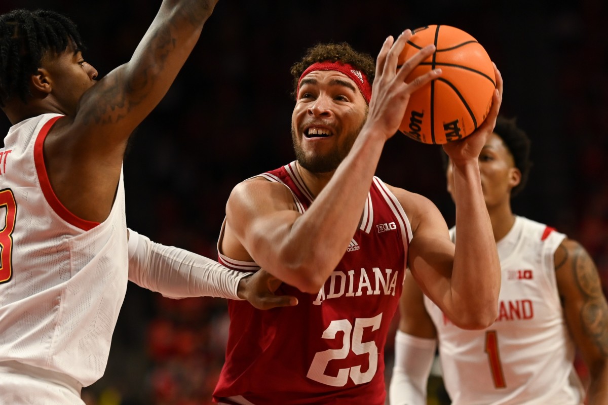 Race Thompson (25) looks to shoots as Maryland Terrapins guard Hakim Hart (13) defends.